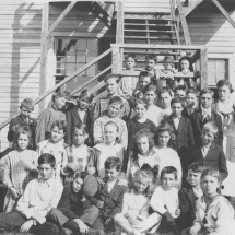Lewisville Academy side view with students, around 1921
